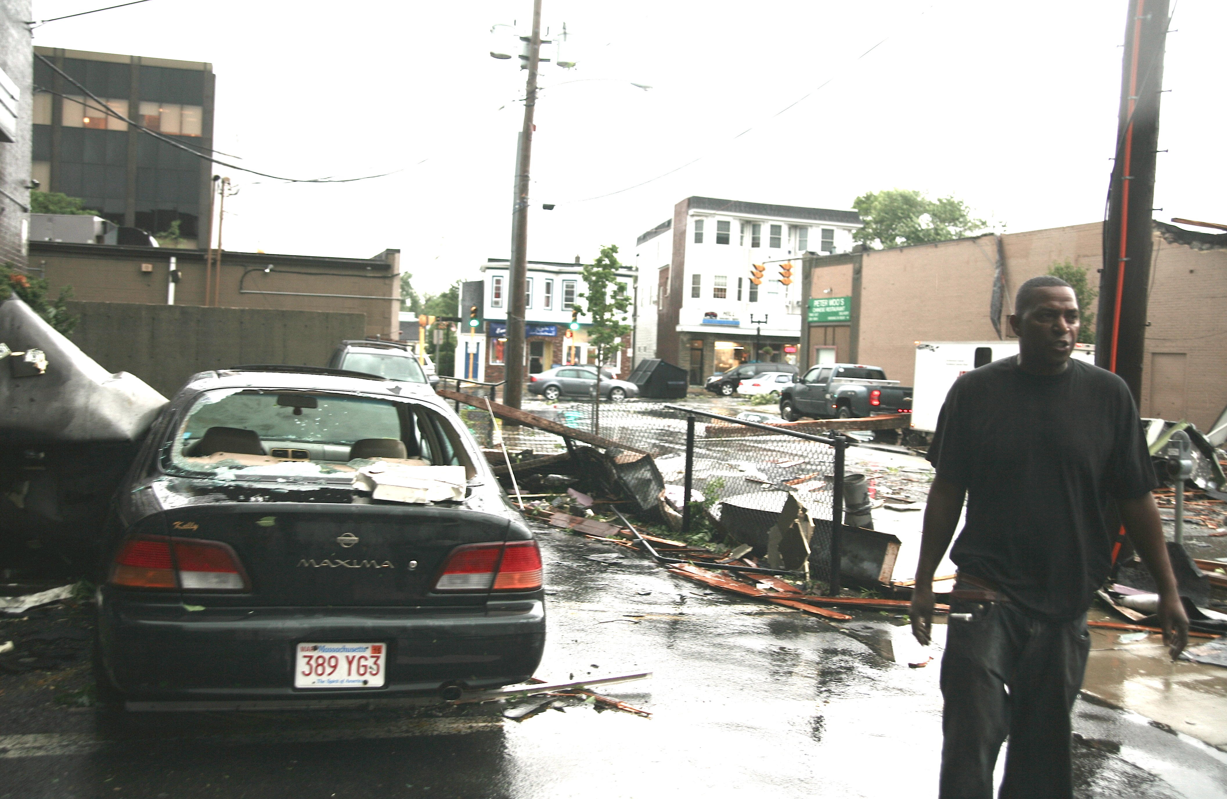 Victor Villena is shown here moments after the tornado passed through Park Avenue. He was in the black car to the left when the tornado struck. Large pieces of Peter Woo’s roof smashed onto his car as he sat inside. “I’m still shaking; it was terrifying,” he said.